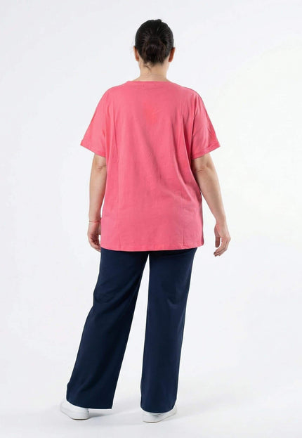Дамска лятна памучна туника в цвят корал, изглед отзад. Моделът е с къс ръкав и свободна кройка, заснет в цял ръст на бял фон.
