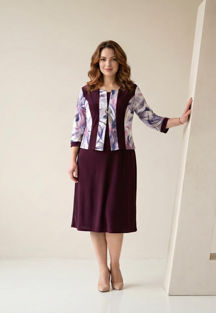 Официална права макси рокля в бордо с ефектни панели с абстрактен принт и брошка, представена в цял ръст отпред върху модел.