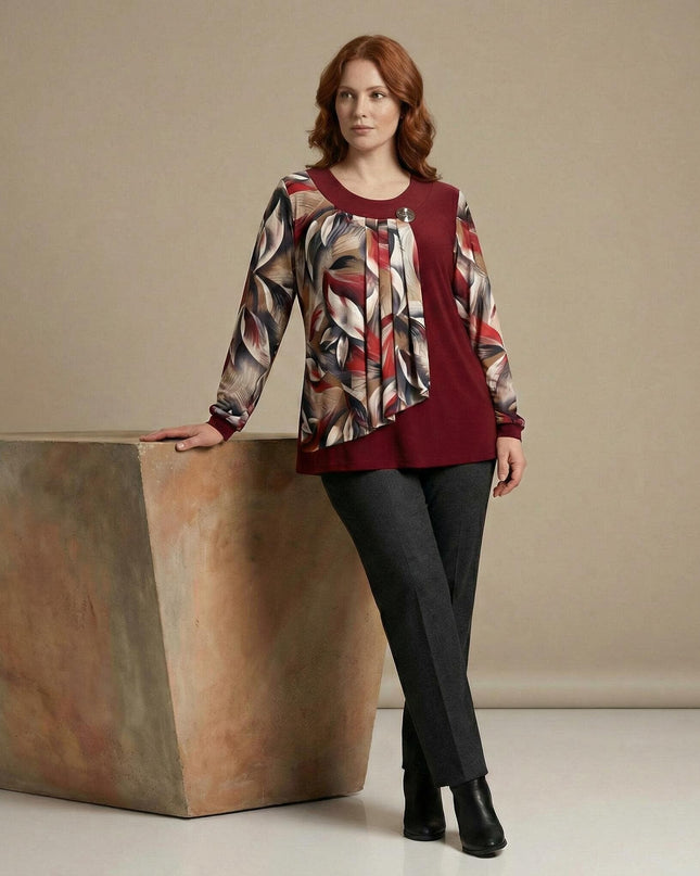 Официална червена туника с флорален шифон и брошка, представена в цял ръст върху модел до интериорен елемент.