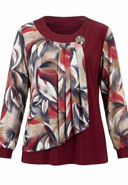 Официална червена туника с драпиран панел от флорален шифон и метална брошка, заснета фронтално на бял фон.