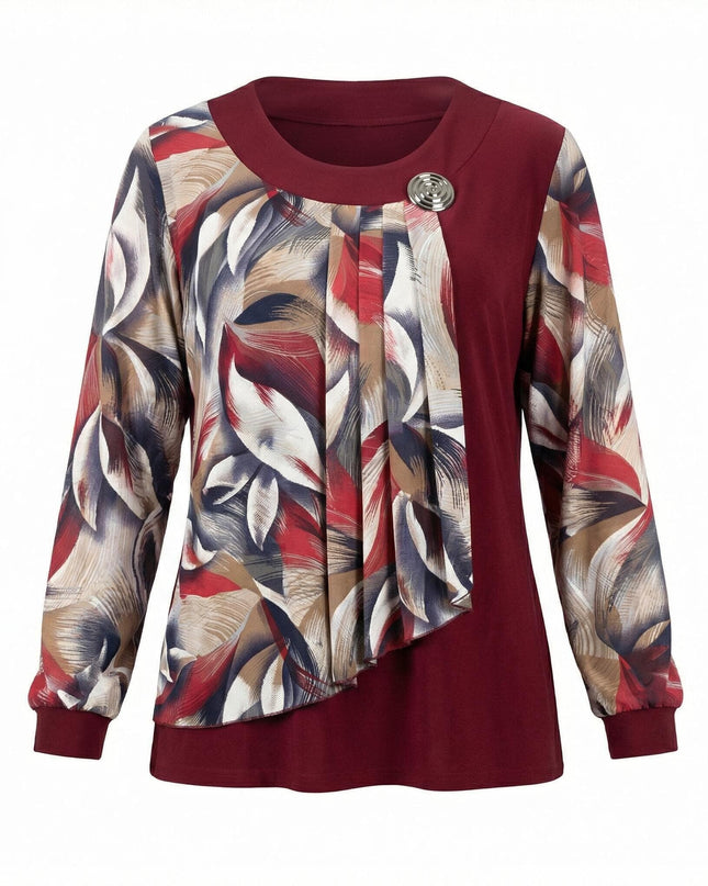 Официална червена туника с драпиран панел от флорален шифон и метална брошка, заснета фронтално на бял фон.