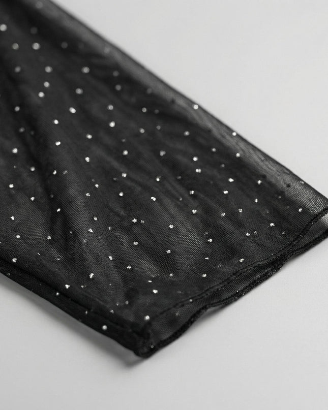 Детайл отблизо на прозрачния ръкав от черен шифон с декоративни блестящи камъни, част от официална макси рокля.