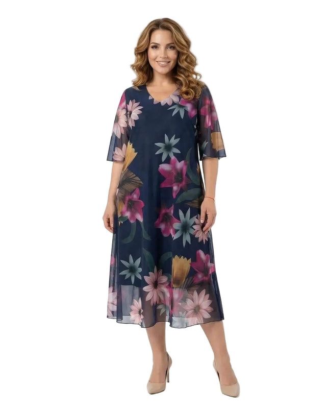 Официална тъмносиня макси рокля с ефирен флорален шифон, снимана в цял ръст отпред на бял фон.