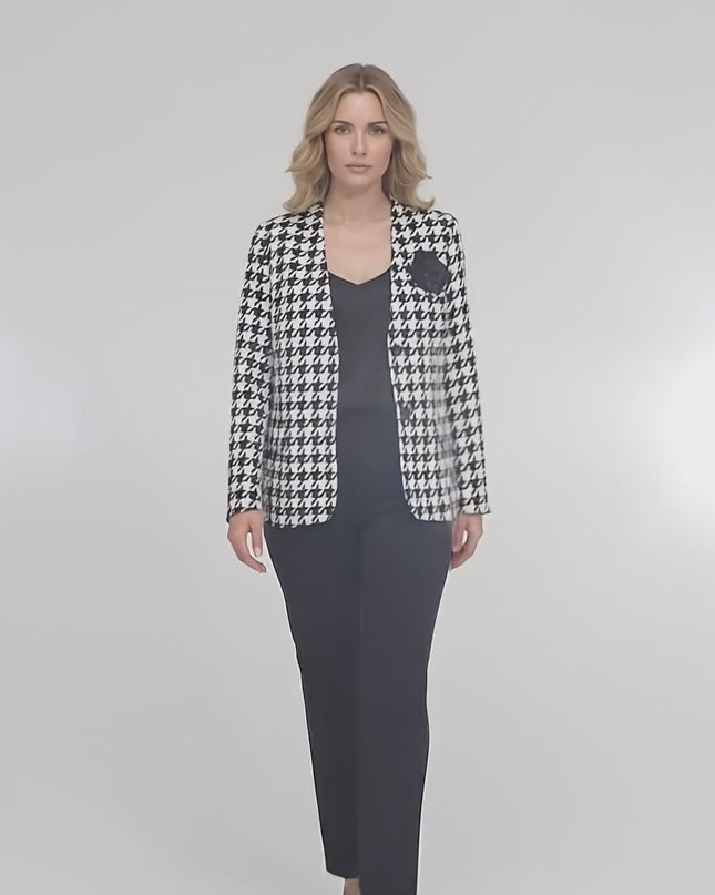 Студийно видео представяне на неутрален фон, в което макси модел върви бавно към камерата и носи Официално дамско сако в пепит с роза и подплата