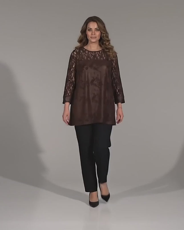 Видео в студийна среда на неутрален фон, показващо макси модел, който върви бавно към камерата и носи Официална макси туника с ефектна дантела в кафяво