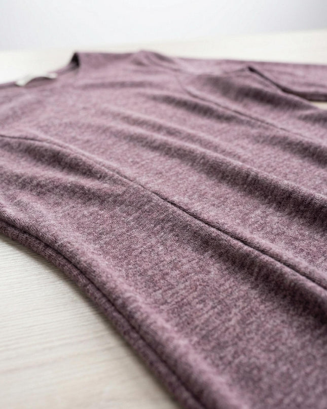 Детайлен кадър на разкроена рокля от плътна вискоза в цвят пепел от рози, показващ текстурата на материята и шевовете в горната част.